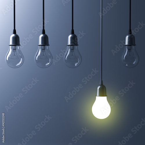 One hanging light bulb glowing different and standing out from unlit incandescent bulbs with reflection on dark cyan background , leadership and different business creative idea concept. 3D rendering.