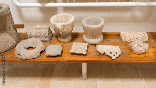 Antique Greek clay pots and stucco moulding fragments on desk. Dion, Pieria, Greece. 