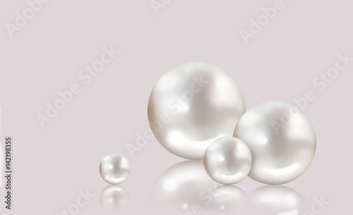 Four white pearls on grey background