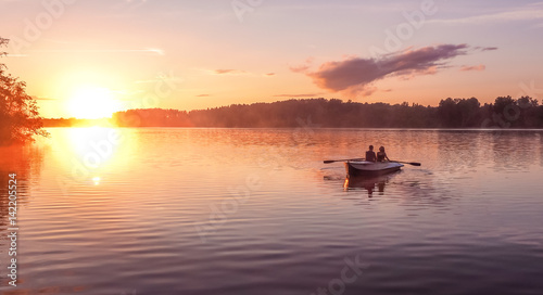 Romantic golden sunset river lake fog loving couple small rowing boat date beautiful Lovers ride during Happy woman man together relaxing water nature around