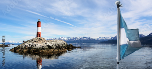 Lighthouse Les eclaireurs in Beagle Channel and blurry Argentina flag