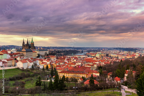 View of Prague and Prague castle from Petrin hill at sunset with dramatic sky. Czechia