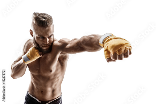 Sporty man throwing a fierce and powerful punch. Photo of muscular man isolated on white background. Strength and motivation