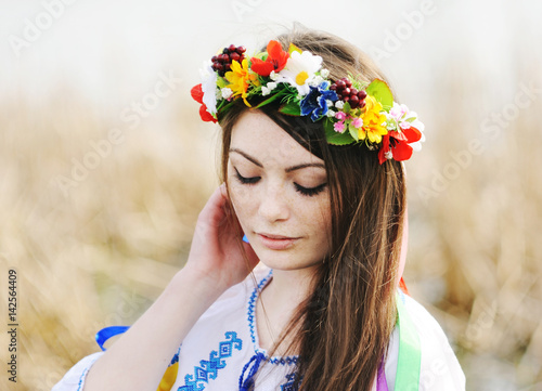 beautiful girl in a white chemise and a wreath of flowers on his head on the background of nature. Ukraine, embroidery, Ivan Kupala day, Midsummer