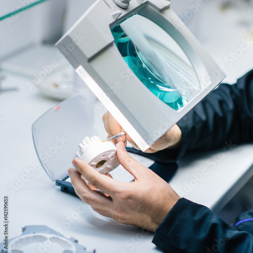 Prosthetic dentistry technician working in his office