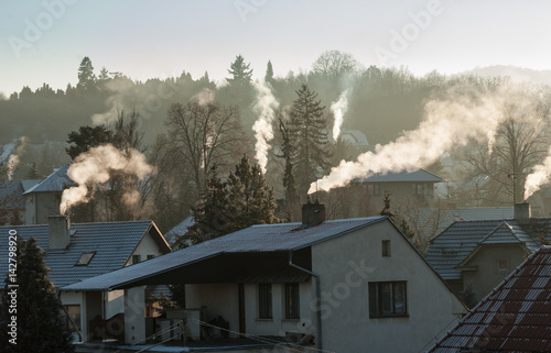 Smoking chimney smoke pollution, small house town in Europe