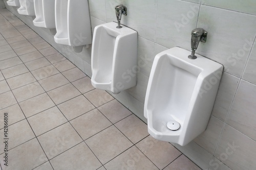 row of outdoor urinal men public toilet white urinals in men bathroom