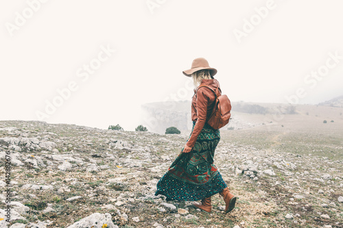 Woman in boho clothing traveling in fog weather