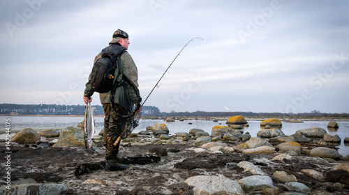 Lonely angler with big sea trout