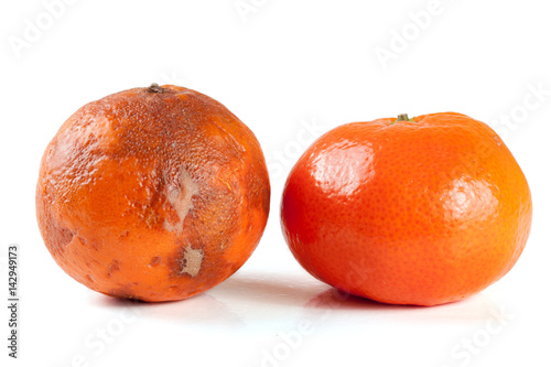 fresh and damaged tangerine isolated on white background