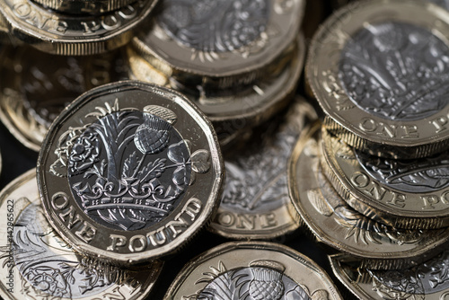 stack of new pound coins introduced in Britain in 2017, front and back