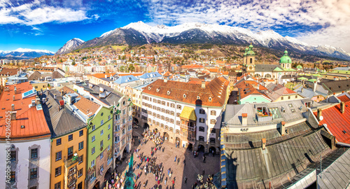 City scape in Innsbruck city center with beautiful houses, river Inn and Tyrolian Alps, Austria, Europe.