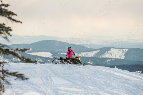 Rider on the snowmobile in the mountains