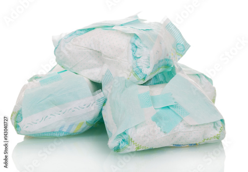 Used disposable diapers close-up isolated on white.