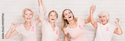 Laughing women with breast cancer ribbons