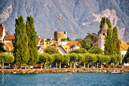 Town with towers and Alps mountains and Geneva Lake Vevey