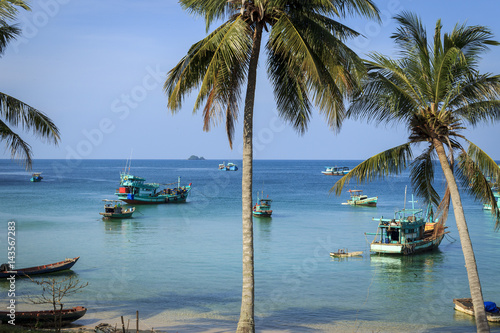Beach sea with Palm trees and boat.