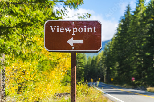 viewpoint sign and arrow with forest background.