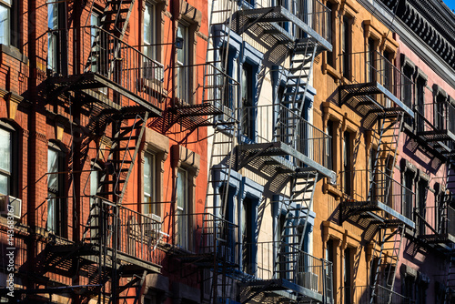 Colorful Soho building facades with painted fire escapes. Manhattan, New York City