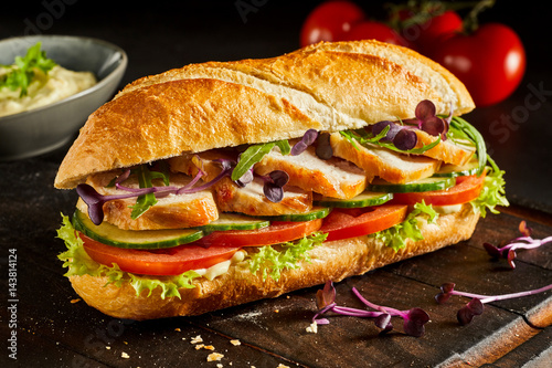 Sliced chicken breast and salad baguette