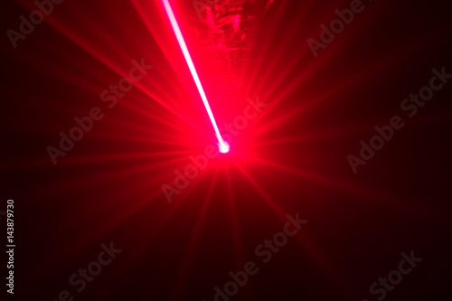 Green and red laser in a nightclub. Laser beams on a dark background, club atmosphere