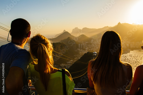 Tourists watching from the Sugarloaf mountain over Rio to Corcovado on a beautiful evening