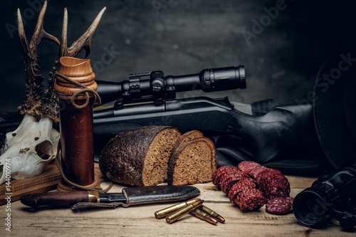 Retro hunting ammunition of rifle and binoculars.