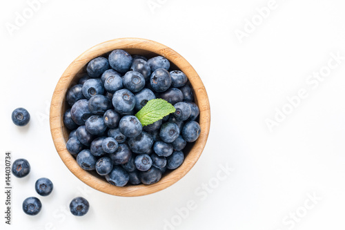 Bowl of fresh blueberries isolated on white, top view copy space