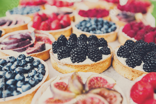 Closeup of blackberry tart dessert tray assorted