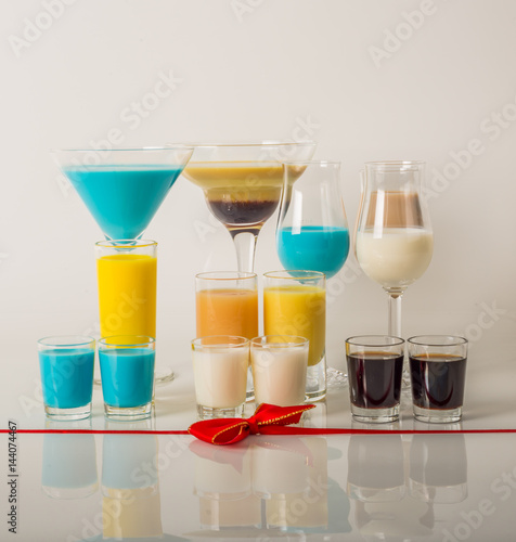Colorful drinks based on milk liqueurs, unique pastel colors of drinks in different glasses, spring drinks