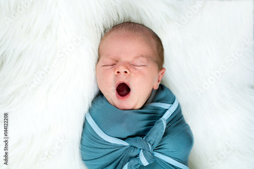 Close up of newborn baby boy yawning