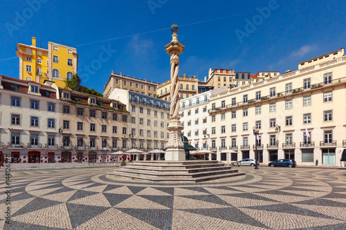 Town Hall Square with a beautiful geometric mosaic in Lisbon, Portugal. In the center of the square the pillory The Pelourinho de Lisboa