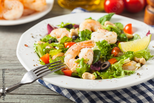 Shrimp salad with tomato, olives and cashew nuts.