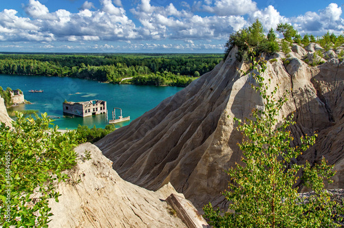 mountain, forest and turquoise lake in the village of Rummu. Abandoned quarry for extraction of limestone. Beautiful nature, attraction in Estonia. The summer season.