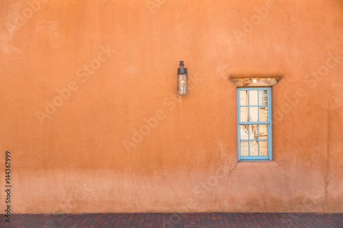 orange wall with turquoise window in Santa Fe, New Mexico