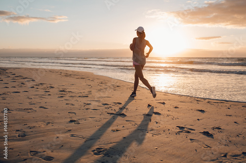 Young woman running on the beach