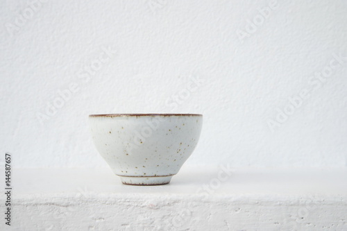white ceramic tea cup with cement wall background