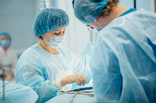 two surgeons at work in operating room. close up