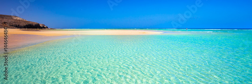 Island with sandy beach, green lagoon and clear water, Fuerteventura, Canary island, Spain.