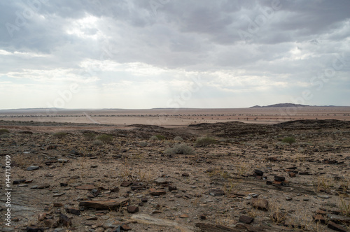 Stony Desert with Mountains and Dirt Road between Walvis Bay and Solitaire in Namibia