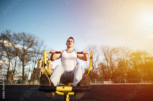 Man do workout at stadium area with sunshine background