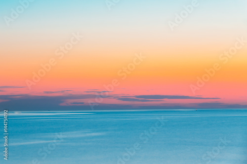 Calm Sea Or Ocean And Colorful Sunset Or Sunrise Sky Background.