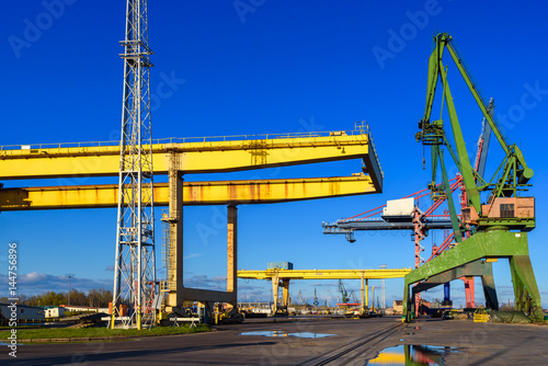 Yellow gantry cranes and green crane in the port of Gdansk. Poland.