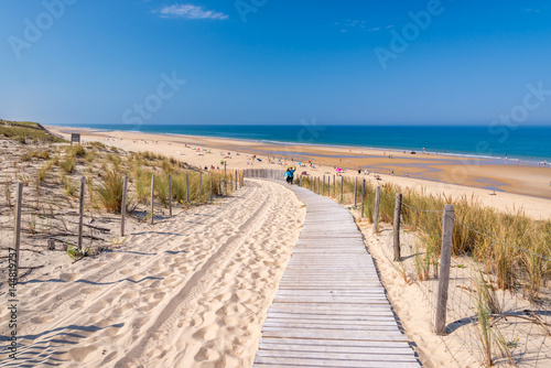 Wooden footpath in the sand dune and the beach of Lacanau, atlantic ocean, Gironde landscape, France