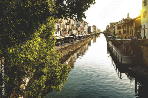 The Naviglio Grande canal waterway in Milan, Italy, at sunset. This district is famous for its restaurants, cafes, pubs and nightlife. 
