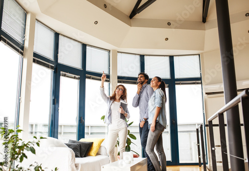 Female Real Estate agent offer home ownership to young couple.