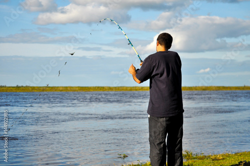 Young Man Fishing At Parana River