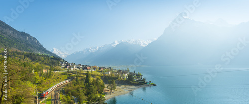 Small towns in Europe. Fluelen. Switzerland. View of the small town in the Alps mountains. Traditional houses. Railway along Lake Lucerne. Canton Uri.