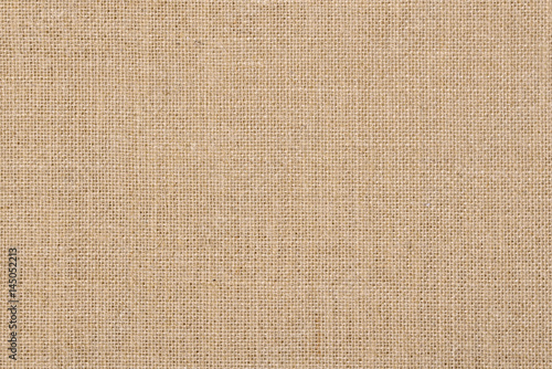 A background of a scratchy burlack material in an even light brown color.