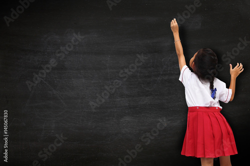 Girl drawing on blackboard